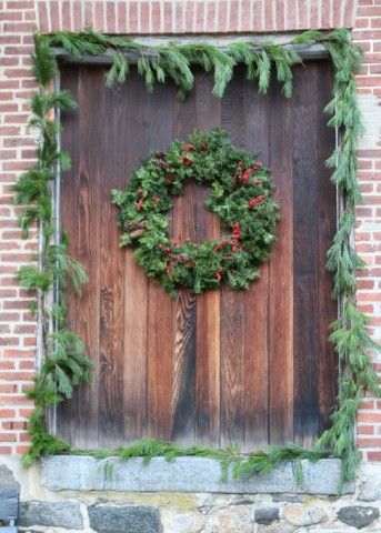 Green holiday wreath and trimmings on the facade of the Brandywine River Museum of Art