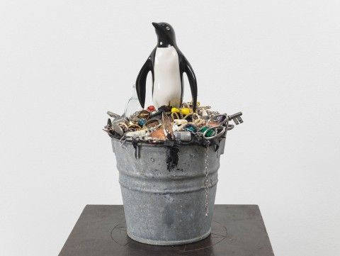 Mark Dion, Nature Morte, 2018. Ceramic penguin, tar, metal bucket, various dime store trinkets and costume jewelry, 38 3/4 x 10 7.8 x 10 3/4 in. Courtesy of the artist and Tanya Bonakdar Gallery, New York / Los Angeles.