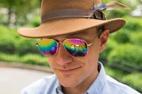 image of teaching instructor Marshall James Kavanaugh wearing colorful sunglasses with a typewriter reflected in the lenses.