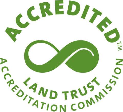 Green seal with the words "Accredited" at the top, an infinity symbol in the middle, and the words "Land Trust Accreditation Commission" at the bottom