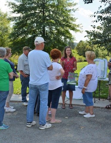 The Brandywine's Melissa Reckner (red shirt) speaks to participants about monarchs and shows examples in their various stages. Photo courtesy SAMA. 