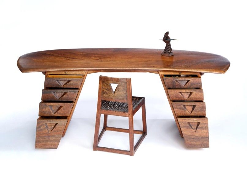 Wood desk and chair with a bronze sculpture on top