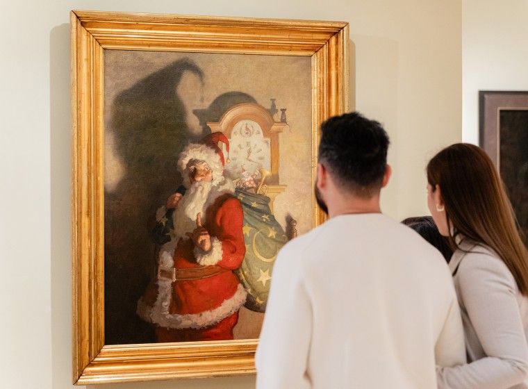Photo of young family looking at N.C. Wyeth's "Old Kris" painting