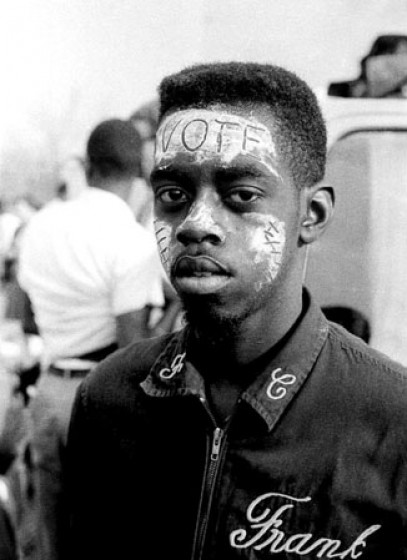 "Vote" written in sunscreen on the forehead of marcher Bobby Simmons.