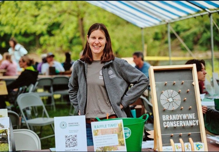 A volunteer tabling an event for the Brandywine Conservancy